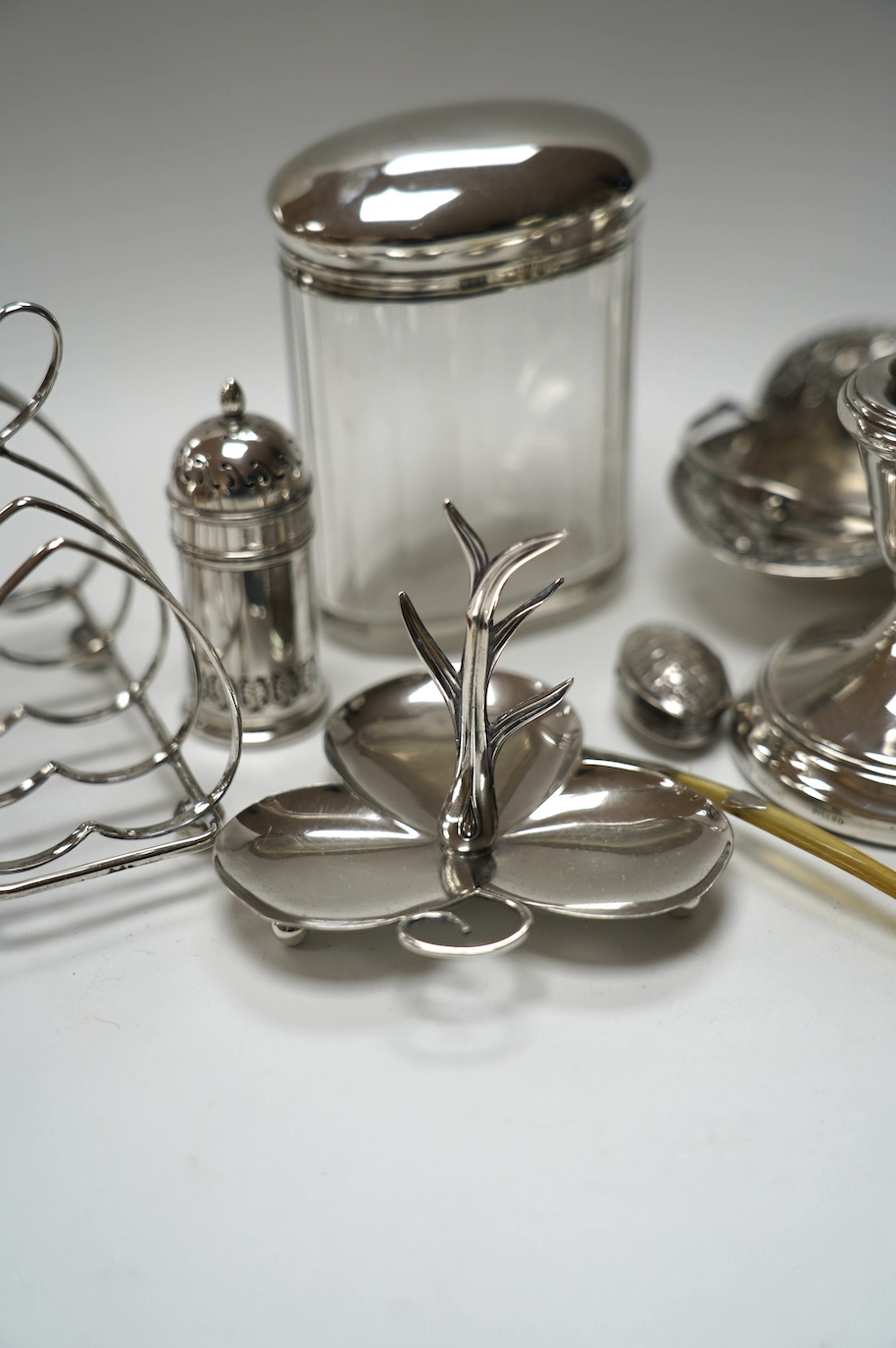 A group of mixed silver including a five bar toastrack, pair of dwarf candlesticks, 19th century snuff box, ring tree dish, cream jug, etc. Condition - poor to fair